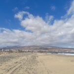 Golden sand beach with a blue sky and white clouds